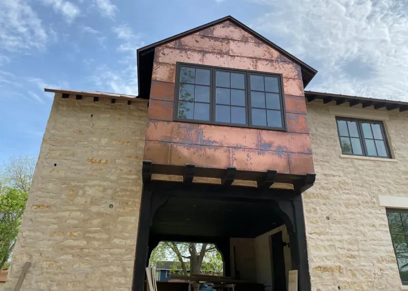 Copper metal panel facade on a stone building for Roof Repair in Pikesville